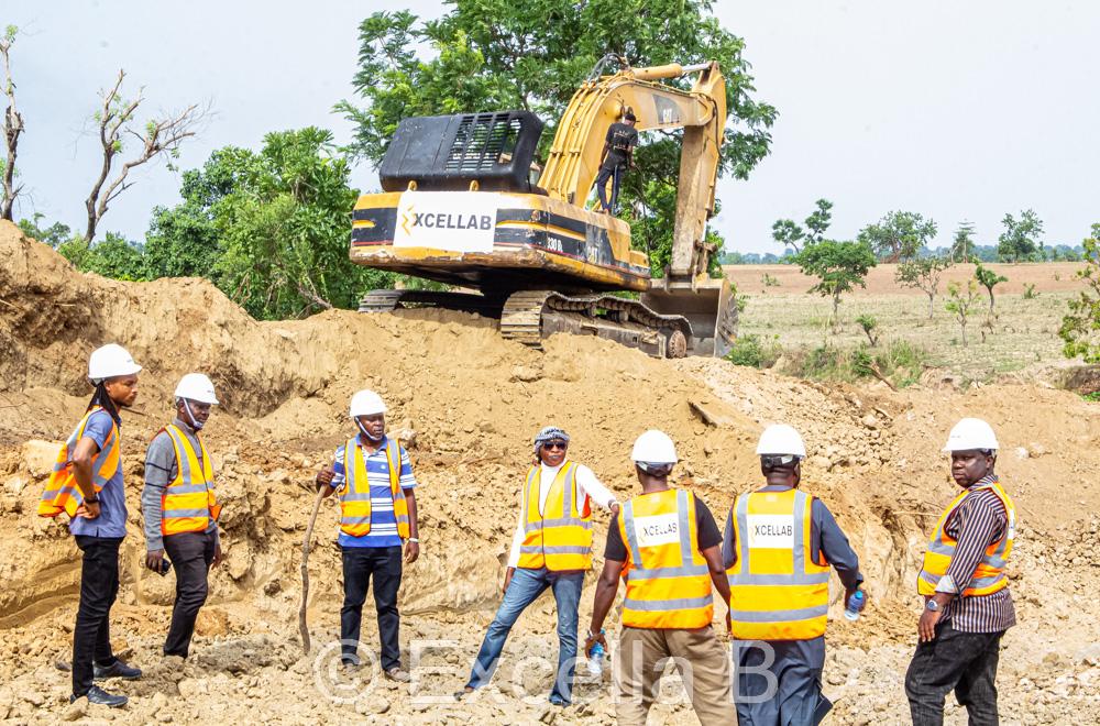 XCELLAB team at mining site with excavator